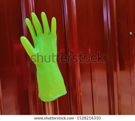 closeup view of green hand glove at the wall