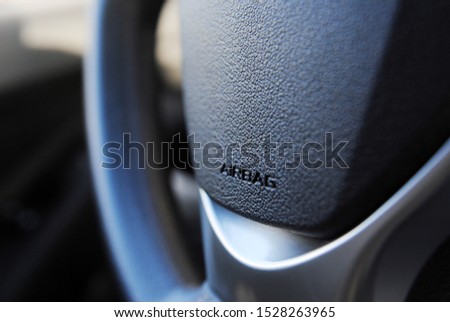 Airbag icon on steering wheel of car close up