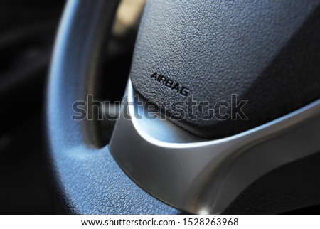 Airbag icon on steering wheel of car close up Royalty-Free Stock Photo #1528263968