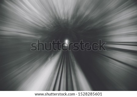 Railway track train crossing a tunnel with copy space transportation one of the way for traveller train trip take with motion blue technic for abstract picture. subway with motion blur color B&W style