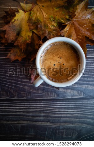 Pumpkin spiced latte on a dark wooden table. Blogging concept. Copy space. Vertical