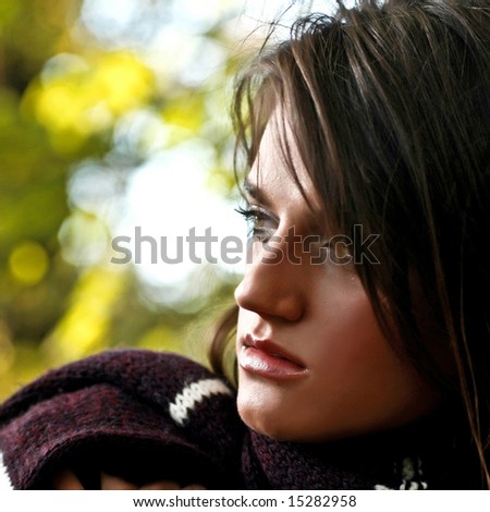Close up portrait of a beautiful and thoughtful young girl. Outdoor background 03