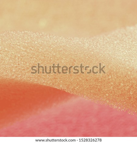 Pink white artificial foam, soft texture on light background.