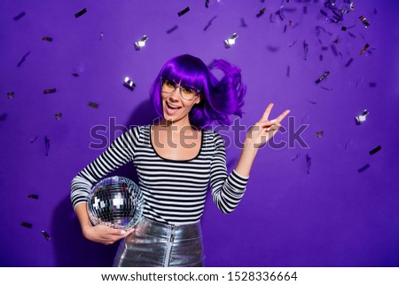 Portrait of charming youth with eyewear eyeglasses make v-signs hold disco ball scream dressed striped trendy shirt isolated over purple background