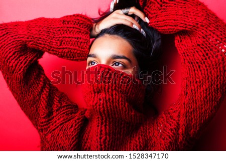 young pretty indian girl in red sweater posing emotional, fashion hipster teenage, lifestyle people concept