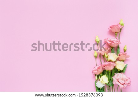 Pink and white eustoma flowers bouquet on pink background. Copy space, top view. Flat lay of International Women's Day, Birthday, Mothers Day concept.