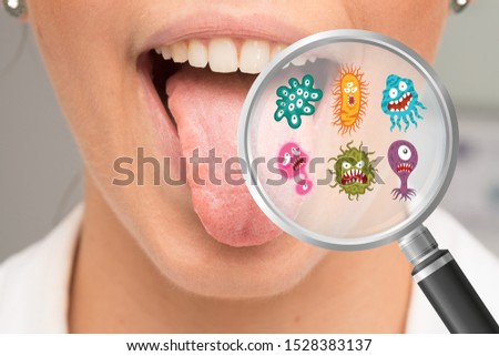 Mouth germs and bacteria in magnifying glass Royalty-Free Stock Photo #1528383137