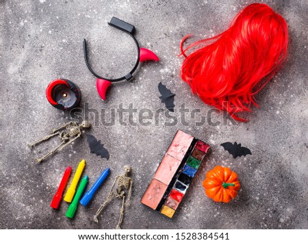 Halloween party accessories. Wigs, candles and face painting