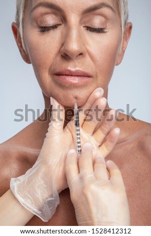 Keep calm. Portrait of delighted woman that keeping eyes closed while suffering pain from prick