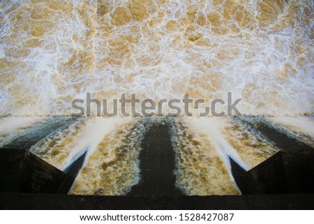 Brown water falling from a dam