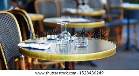 Wine glasses on a table of cozy Parisian outdoor cafe