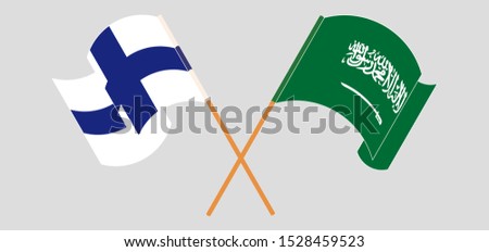 Crossed and waving flags of the Kingdom of Saudi Arabia and Finland