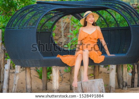 Portrait beautiful young asian woman happy smile relax on the beach sea ocean at sunset time in holiday vacation