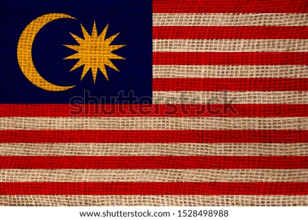beautiful photo of the national flag of Malaysia on delicate shiny silk with soft draperies, the concept of state power, country life, horizontal, close-up, copy space
