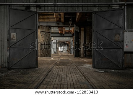Large industrial door in a factory Royalty-Free Stock Photo #152853413