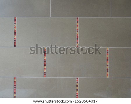 Brown ceramic kitchen tile with stripes burgundy, red and orange. Texture background abstract pattern. Front wiew.