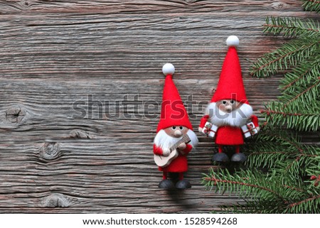 Santa claus with christmas tree and music  on wooden background 