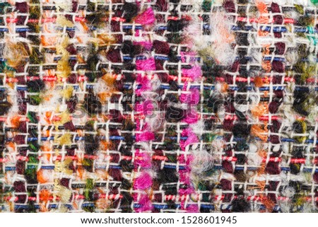 textile background - interlacing of color threads in boucle fabric close up