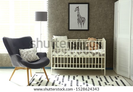 Cozy baby room interior with comfortable crib