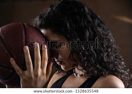 Young sportswoman holding basketball ball