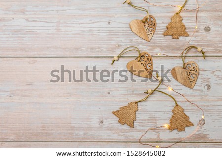wooden Christmas trees and hearts on a gray background