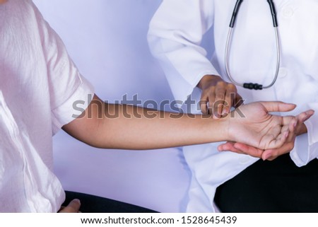 Doctor is looking at the patient's heart rate.