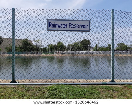 Rain reservoir. Rainwater storage ponds and signs