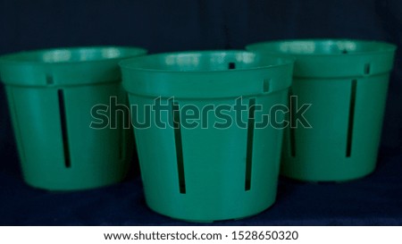empty flower pot isolated on black background, Green pot