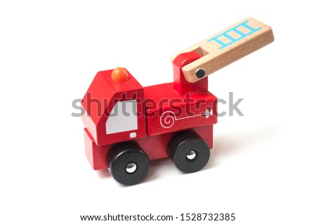 Closeup of miniature toy, wooden fire truck on white background