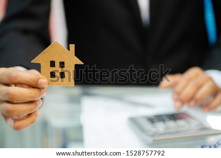 Concept home purchase contract,Businessmen are signing a house purchase contract,The concept of selling a home is signing a contract.