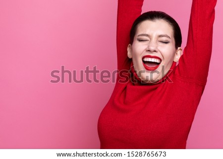 girl in red sweater posing on pink studio background. positive emotions. artistic girl. free space for copy paste
