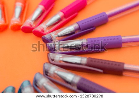 colored pens with their cap