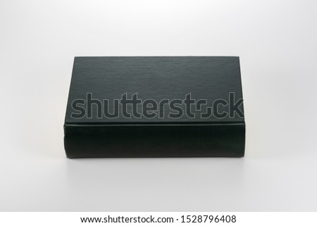 Closed thick book on white background