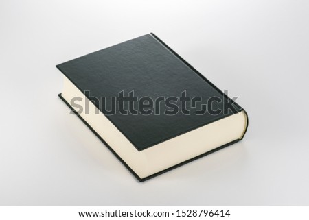 Closed thick book on white background