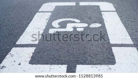 Disabled parking sign on asphalt                               