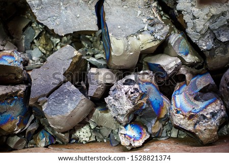 Pieces of ferrotitanium closeup. Ferroalloy used for alloying, deoxidation and degassing of steels and alloys Royalty-Free Stock Photo #1528821374
