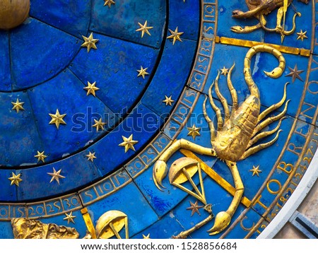 Scorpio astrological sign on ancient clock, Venice, Italy. Detail of Zodiac wheel with scorpion, golden horoscope icon of scorpio closeup. Scorpio symbol on star circle. November and horoscope theme.