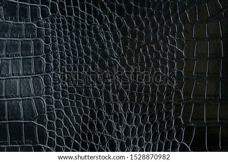 Black crocodile leather texture with for background.