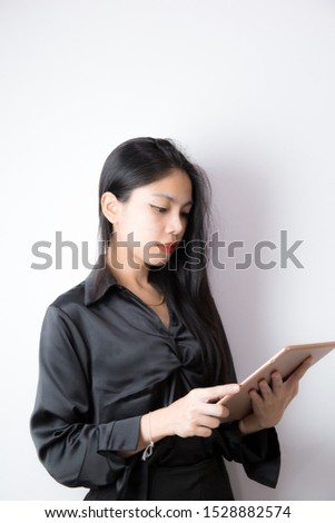 Woman holding a tablet and thinking something.