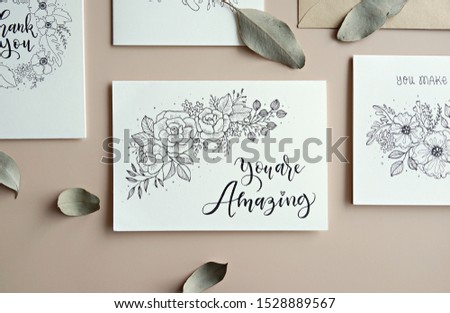 Hand drawn encouraging card with hand lettering quote and floral element. Top view.                 