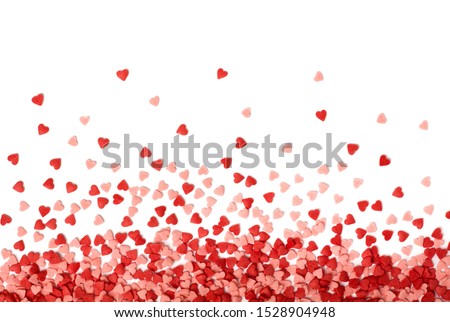 Sugar sprinkle dots hearts, decoration for cake and bakery. Colorful sugar sprinkles scattered on white background. Valentines Day background.
