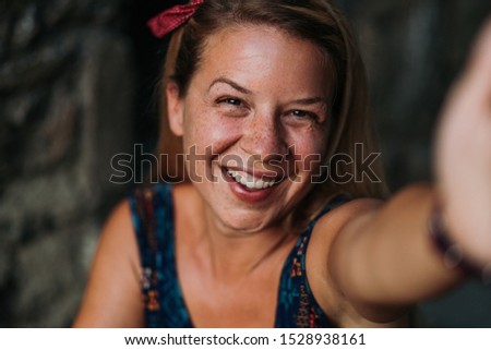 Young cute blonde woman taking a selfie 