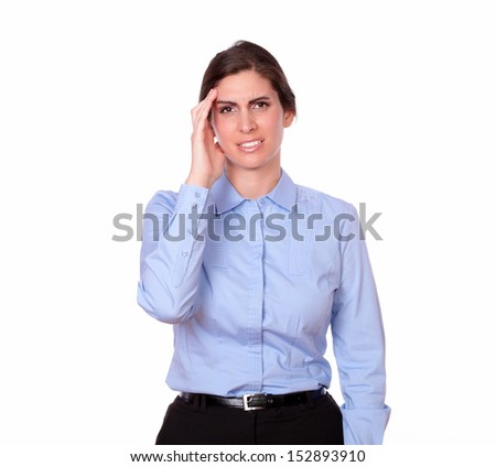 A portrait of a stress gorgeous woman on blue blouse looking at you with headache on isolated studio