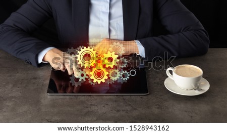 Business woman working on tablet with setting and gear concept