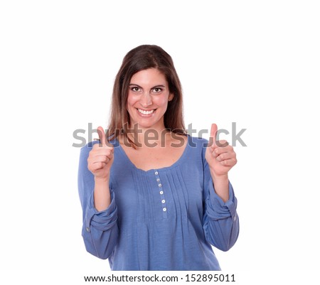 A portrait of a pretty young woman on blue shirt with ok thumb smiling at you on isolated studio