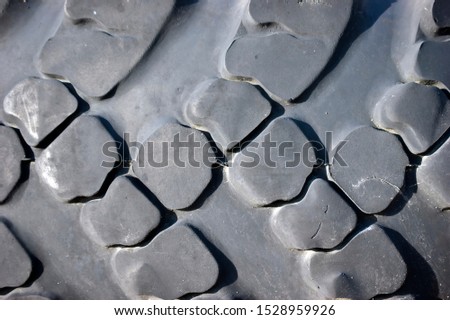 Black rubber tires. Pattern worn tread. Abstract black pattern of squares and rhombuses.