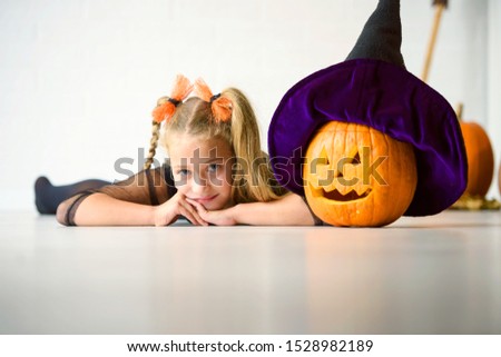 Cute girl in costume ready for trick-or-treating Halloween holiday concept