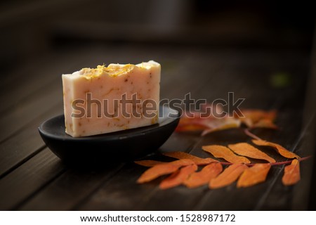 SPA Soap bar, natural organic concept, handmade soap against autumn orange and red  leaves , close up, side view Royalty-Free Stock Photo #1528987172