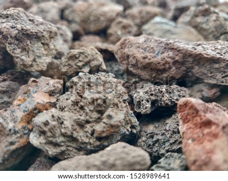 Lava small rocks. Can for example be used as background picture for an outdoor business webpage. Those volcano stones convey sentiments of strength, power, roughness, and power. Perfect for background