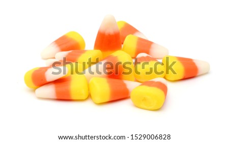 Candy corn in jar on white background 